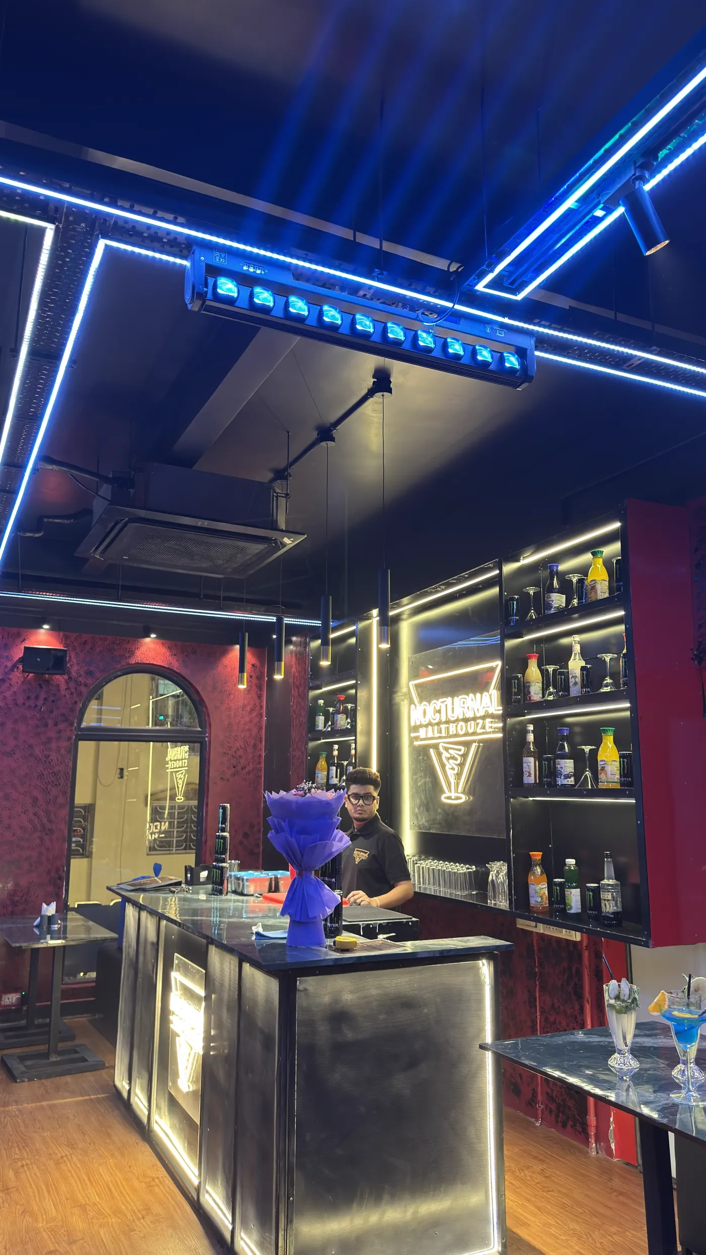The bar, back-lit shelves and the illuminated house sign